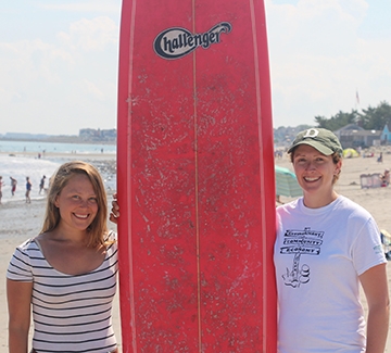 people posing with surf board