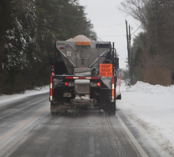truck salting road in winter