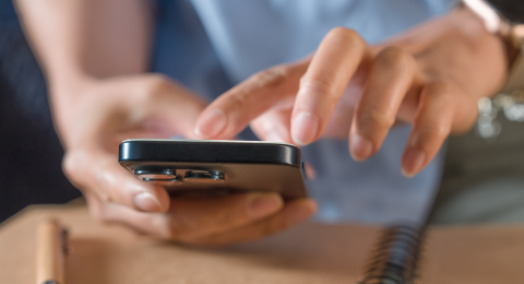 A person inputting data on their calculator