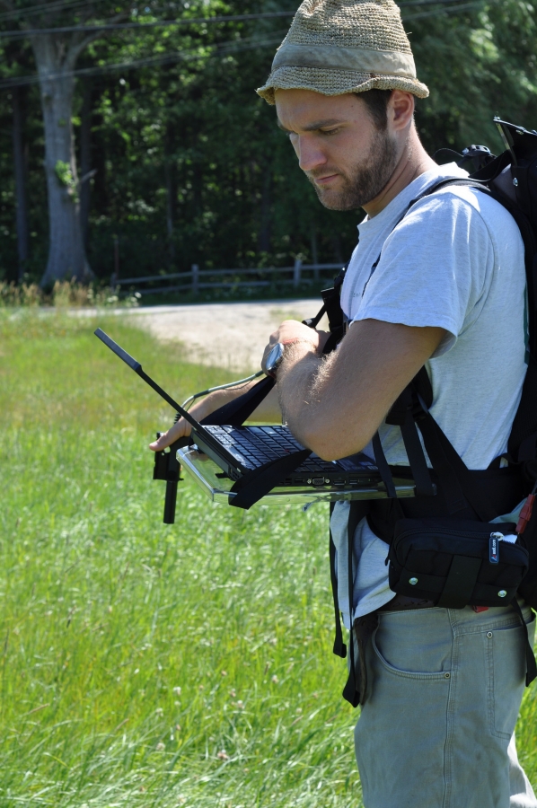 man with laptop outdoors