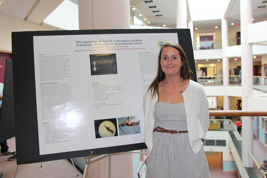woman posing with her research poster