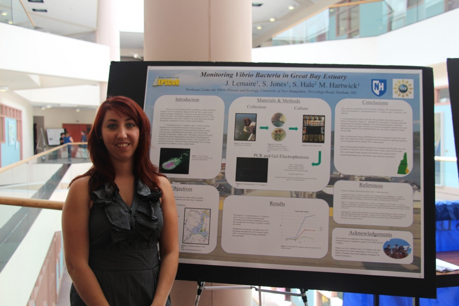 woman presenting research poster 