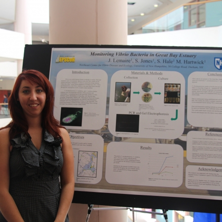 woman presenting research poster 